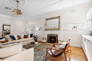 a living room with a couch and a fireplace at Kaya in Collaroy
