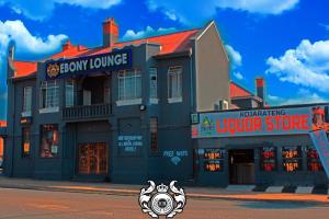 a building on the corner of a street at Ebony Guest House in Pretoria