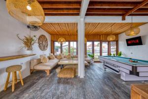 a living room with a pool table and a couch at Villa Cabala Bali in Canggu