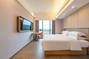 Katil atau katil-katil dalam bilik di Poltton International Apartment - Guangzhou Knowledge City Wangcun Subway Station