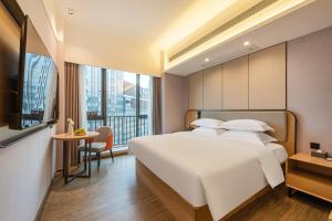 Katil atau katil-katil dalam bilik di Poltton International Apartment - Guangzhou Knowledge City Wangcun Subway Station