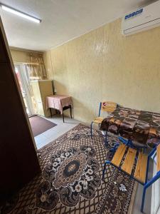 a room with a bed and a rug on the floor at Номера в Фонтанке in Fontanka