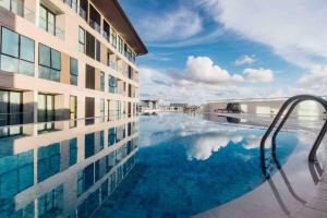 a swimming pool next to a building at Jk DeLOFTS 03 6Pax 150Mbps 2BedR 2BathR 1Carpark in Kuching