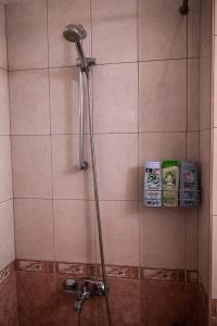 a shower with a shower head in a bathroom at Private studio in the city center, close to subway, Medical University in Sofia