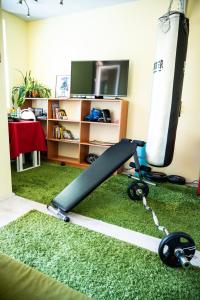 a room with a surfboard and a treadmill at Private studio in the city center, close to subway, Medical University in Sofia