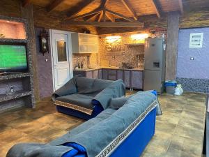 a living room with a couch and a television at Stefania's house in Agia Effimia