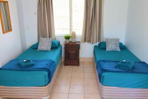 Postel nebo postele na pokoji v ubytování Cooktown Motel