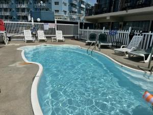 a large swimming pool with chairs at Paradise Inn in Wildwood