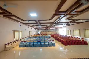 an empty hall with blue and red chairs in it at Kwality Beach Resort in Beni Ghāt
