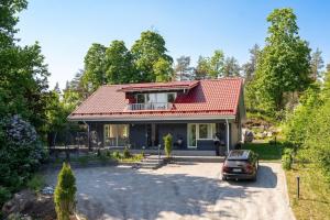 a house with a car parked in front of it at Beautiful house in peaceful area in Vantaa