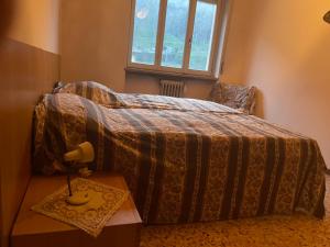 Postel nebo postele na pokoji v ubytování Laghi di Como appartamento di Licinia e Mario