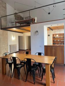 a dining room with a wooden table and chairs at Palazzo Verrone in Bari