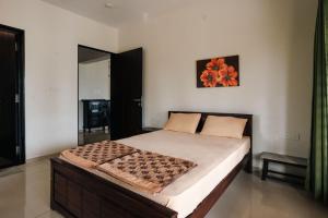 a bedroom with a large bed in a room at Sand Ranch by EWA Properties in Suratakal