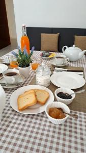 a table with a plate of bread and other food at La tappa del vignaiolo B&B in Mamoiada