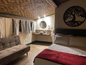 a bedroom with a bed and a couch in it at Hospedagem Casa 46 in Bonfim