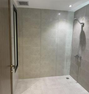 a shower with a glass door in a bathroom at شقة فاخرة قرب الحرم النبوي in Al Madinah +70 photos