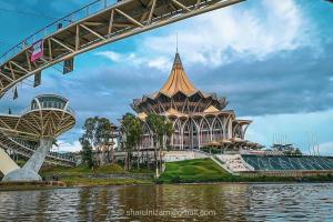 a building with a bridge over a body of water at Jk CozyHome 10Pax 100Mbps 2Carparks in Kuching
