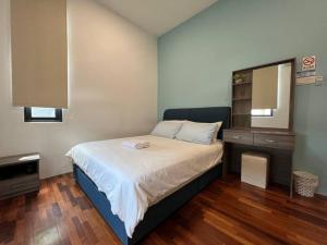 a small bedroom with a bed and a mirror at Jk CozyHome 10Pax 100Mbps 2Carparks in Kuching +56 photos