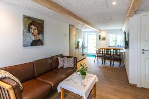 a living room with a couch and a table at Lejlighed D in Vejle