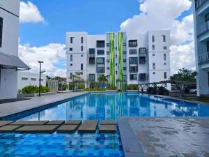 a large swimming pool with buildings in the background at Jk CozyHome 02 8Pax 100Mbps 2Carparks in Kuching