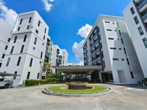 a fountain in a courtyard between two tall buildings at Jk CozyHome 02 8Pax 100Mbps 2Carparks in Kuching