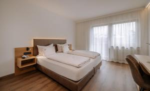 Postel nebo postele na pokoji v ubytování Garni-Hotel Farmerhof