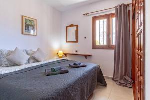 a bedroom with a bed with two towels on it at Cliff View Terrace By Dream Homes Tenerife in Puerto de Santiago