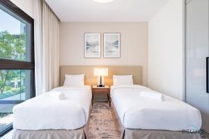 Katil atau katil-katil dalam bilik di Waterfront 2BR in The Address Fujairah Residences Block C, Sharm by Deluxe Holiday Homes