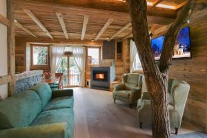 a living room with a couch and a fireplace at Neuprantl Apartments in Lana