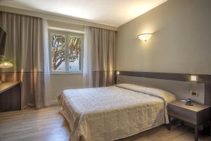 a bedroom with a bed and a window at Grande Albergo in Sestri Levante