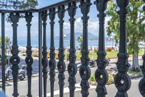 a black fence with a view of the water at Grande Albergo in Sestri Levante