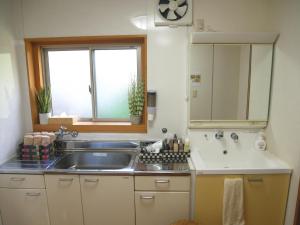 a small kitchen with a sink and a window at 大阪西九条stay屋上BBQ可 in Osaka +49 photos
