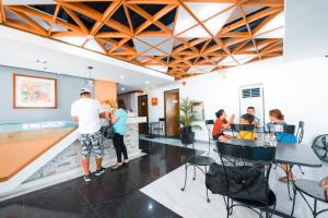 a group of people sitting at a bar in a restaurant at Travelbee Fuente Inn in Cebu City
