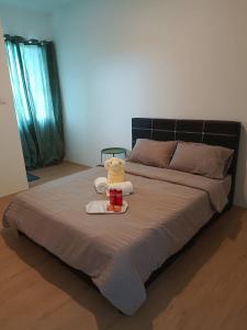 a bed with a stuffed animal sitting on top of it at Loft Suites 01 - Skyline Suite in Kuching