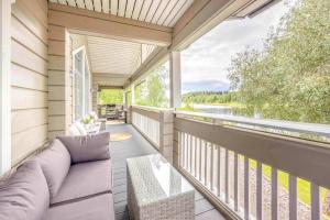 a porch with a couch and a view of the water at Holiday Villa Himos Hopearanta in Himos