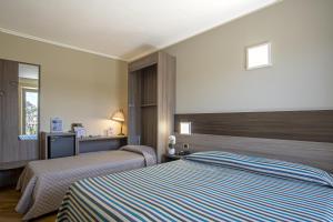 a hotel room with two beds and a television at Grande Albergo in Sestri Levante