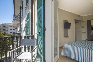 a balcony with a bed and a chair on a balcony at Grande Albergo in Sestri Levante