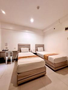 Ένα ή περισσότερα κρεβάτια σε δωμάτιο στο Travelbee Fuente Inn