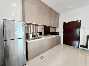 a large kitchen with a stainless steel refrigerator at Jk CozyStay 10Pax 300Mbps 3BedR 2BathR 2ShadedCarpark in Kuching