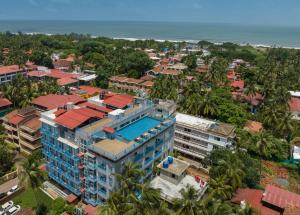 an aerial view of a building with the ocean in the background at De Mandarin Candolim Beach Goa in Candolim