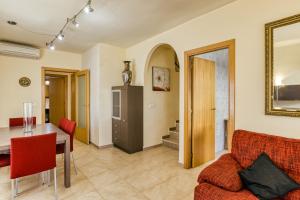 a living room with a table and a couch at Les Medes in L'Estartit