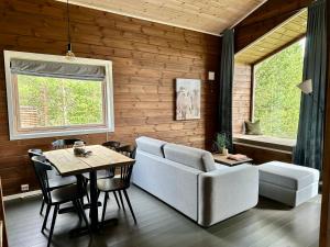 a living room with a table and a couch and a chair at Bjørnfjell Mountain Lodge in Alta