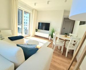 a living room with a couch and a table at VIP APARTAMENTY Lubelska in Rzeszów