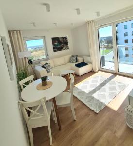 a living room with a table and a couch at VIP APARTAMENTY Lubelska in Rzeszów