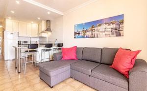 a living room with a couch and a kitchen at Seaside Escape 2bed By Dream Homes Tenerife in Puerto de Santiago