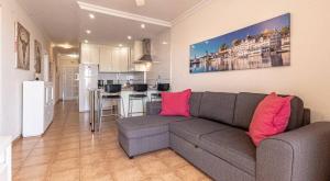a living room with a couch and a kitchen at Seaside Escape 2bed By Dream Homes Tenerife in Puerto de Santiago +20 photos