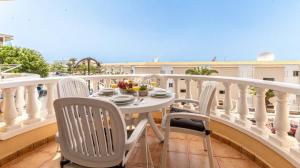 a balcony with a table and chairs on a balcony at Seaside Escape 2bed By Dream Homes Tenerife in Puerto de Santiago