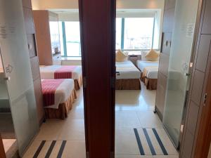 Giường trong phòng chung tại Rambler Oasis Hotel