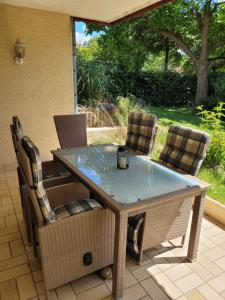 a table and chairs sitting on a patio at Ferienwohnung Westerwaldblick großzügige Wohlfühloase mit Terrasse in Oberelbert +18 photos
