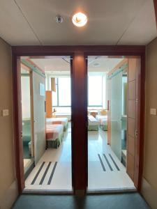 A bed or beds in a room at Rambler Garden Hotel